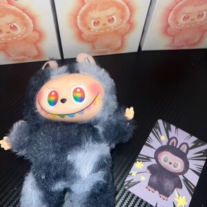 Fluffy Black Plush Monster with Rainbow Eyes